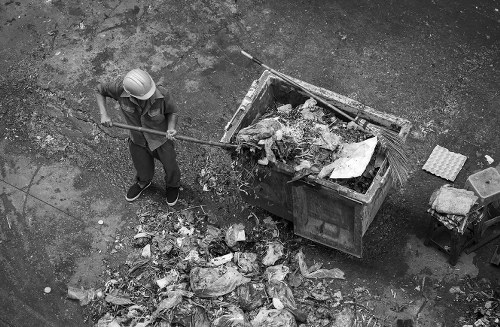 Workers performing site clearance in an urban area of Staines