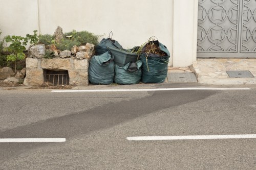 Man and van loading furniture in a narrow street