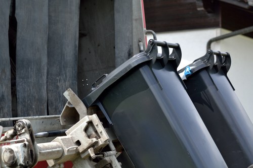 Operatives wearing PPE loading a skip safely